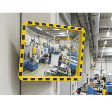 Rechteckiger Sicherheitsspiegel für Industrie und Lager mit gelb-schwarzem Warnrahmen an einer Wand montiert.