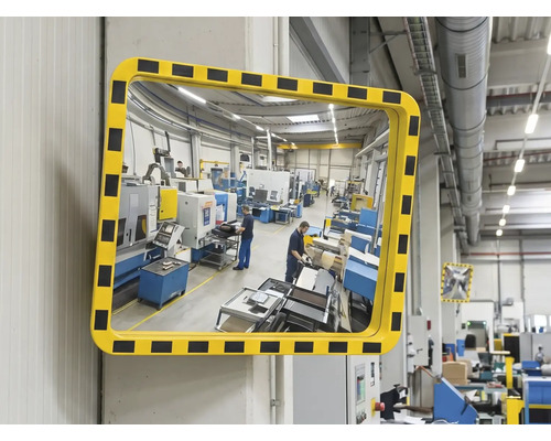 Rechteckiger Sicherheitsspiegel für Industrie und Lager mit gelb-schwarzem Warnrahmen an einer Wand montiert.
