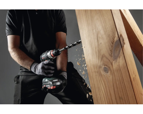 Person bohrt mit einem Metabo Akku-Bohrschrauber in einen Holzbalken.