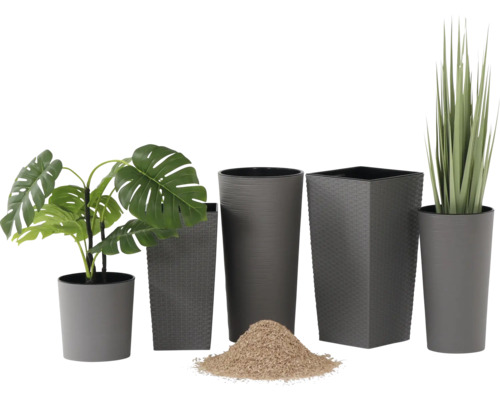 Graue Blumentöpfe in verschiedenen Größen und Formen, rund und quadratisch, mit Monstera, Ziergras und Pflanzsubstrat.