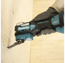 Makita Multifunktionswerkzeug mit bürstenlosem Motor und Anti-Vibrations-Technologie sägt eine quadratische Öffnung in eine Holzplatte.