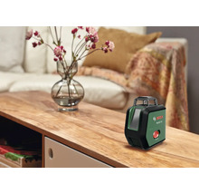 Bosch PLL 360 15G Kreuzlinienlaser auf einem Holztisch im Wohnzimmer stehend