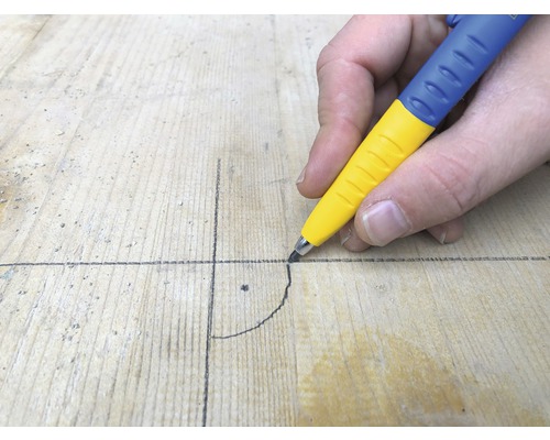 Eine Person zeichnet mit einem Zimmermannsbleistift eine Linie auf ein Holzbrett.
