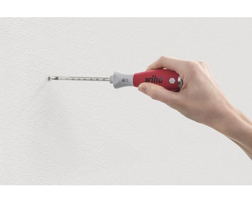 Eine Hand schraubt mit einem Wiha Schraubendreher eine Schraube in die Wand.