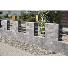 Betonmauer mit Metallgeländer und Zierkies