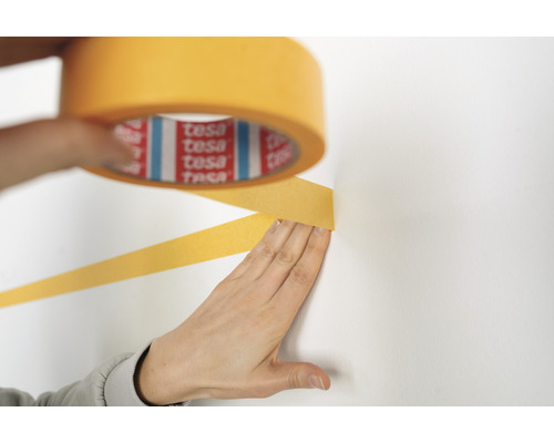 Abdeckband wird an einer Wand angebracht