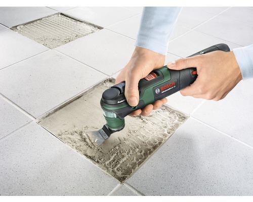 Person entfernt Fliesen mit einem Multifunktionswerkzeug von Bosch