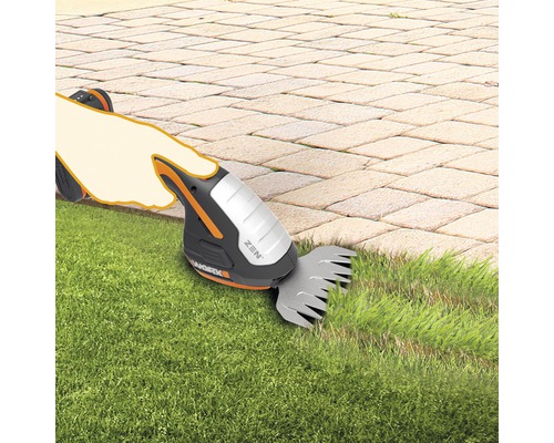 Akkugrasschere im Einsatz zum Kantenschneiden des Rasens