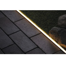 Szene mit Pflastersteinen, Rasen, Steinen und LED-Leuchte