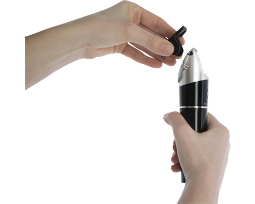 Hände setzen einen schwarzen Nasenhaartrimmeraufsatz auf den Trimmer