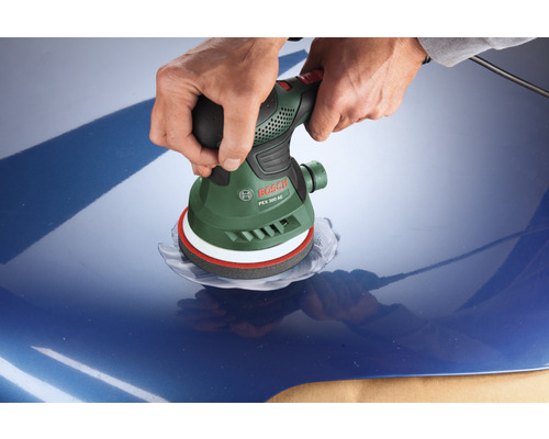 Eine Person schleift mit einem Exzenterschleifer von Bosch ein blaues Auto.