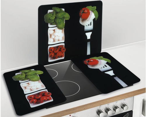 Herdabdeckplatten aus Glas mit Lebensmittelmotiven auf einem Herd
