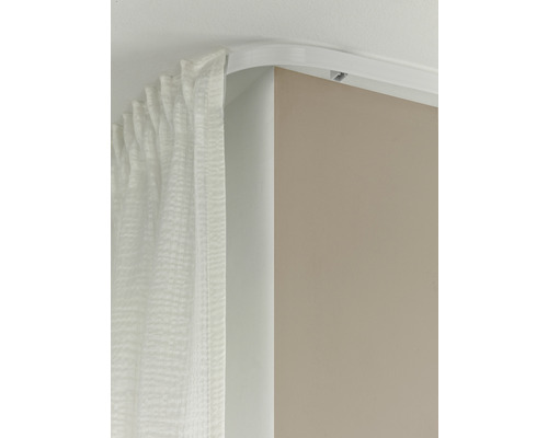 Gebogene Vorhangschiene mit Vorhang an der Decke montiert.