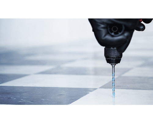 Bohrmaschine bohrt Loch in Fliese