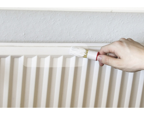 Heizkörper wird mit Heizkörperpinsel gestrichen