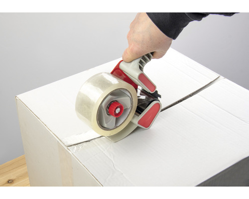 Karton wird mit einem Packbandabroller verschlossen