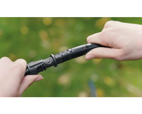 Zwei Hände verbinden einen Bewässerungsschlauch.