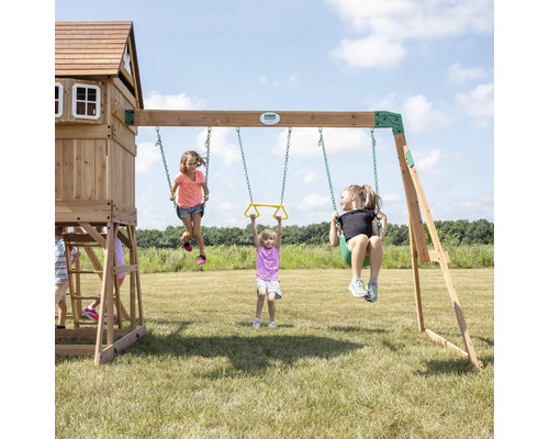 Spielplatz mit Schaukeln, Turm und Kindern auf einer Rasenfläche