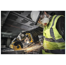 Arbeiter mit Schutzhelm, Schutzbrille, Atemschutzmaske und Warnweste beim Trennen von Metall mit einem Winkelschleifer von DeWalt.