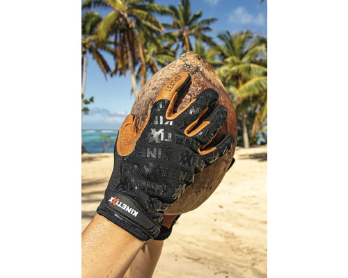 Hand mit KINETIXX Arbeitshandschuhen hält eine Kokosnuss am Strand