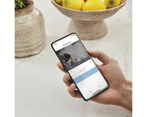 Eine Person hält ein Smartphone, auf dem eine Videoaufnahme angezeigt wird.