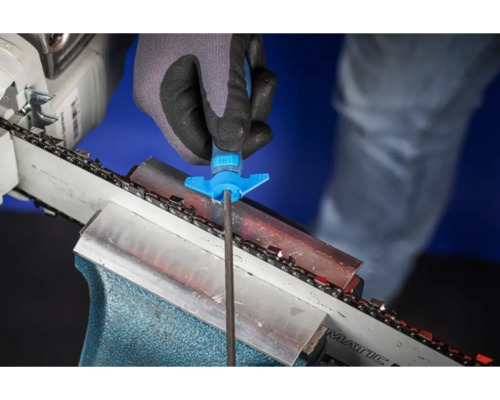 Eine Person schärft eine Kettensäge mit einer Feile