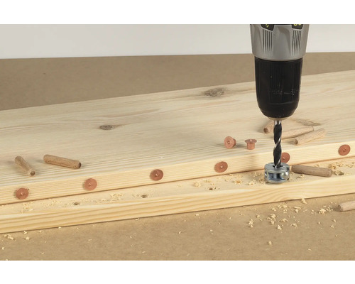 Holzbretter werden mit Dübeln und einer Bohrmaschine verbunden