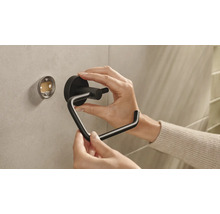 Installation eines schwarzen Toilettenpapierhalters an der Wand