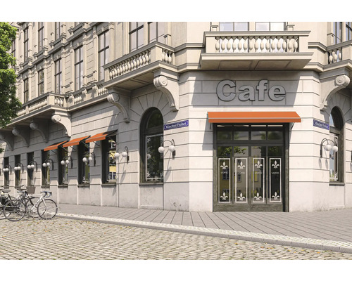 Außenansicht eines Cafés mit Markisen und Fahrrädern vor dem Gebäude.