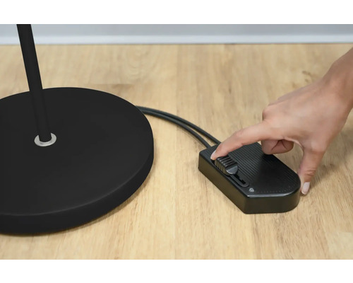 Detailansicht einer Stehlampe mit Dimmschalter in Bedienung.