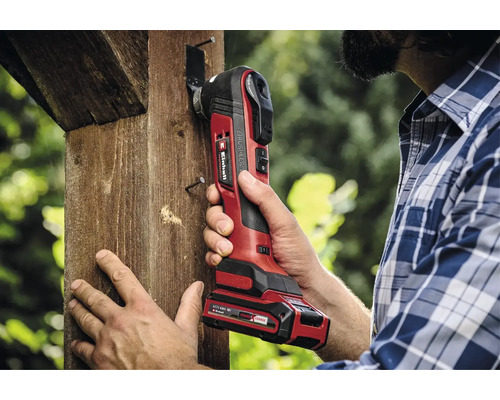 Ein Mann benutzt ein Einhell Akku-Multifunktionswerkzeug an einem Holzbalken