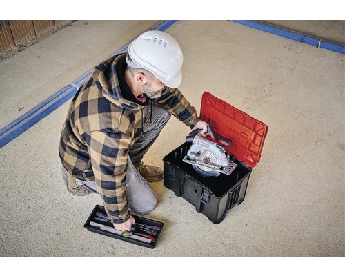Handwerker mit Kreissäge in Werkzeugkiste und Wasserwaage im Setkasten