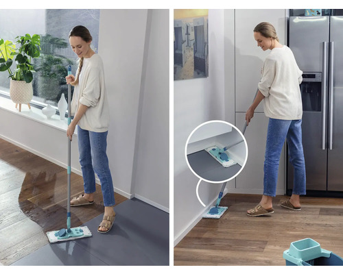 Frau wischt mit einem Mopp einen Boden in einem Haus.