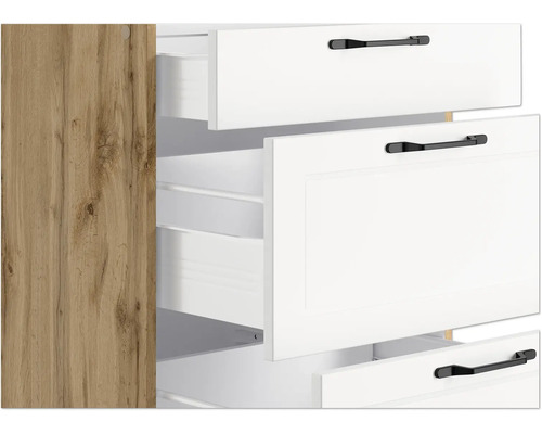 Detailansicht eines Schranks mit weißen Schubladen und Griffen sowie einer Seitenwand in Holzoptik.