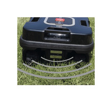 Detailansicht eines Rasenmähroboters auf Gras mit Ultraschallsensoren.