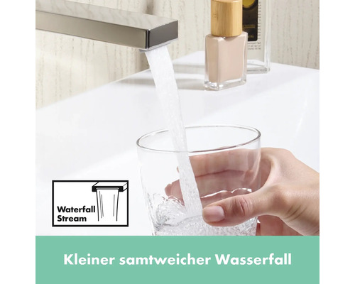 Wasserhahn mit Wasserfallstrahl füllt ein Glas mit Wasser.