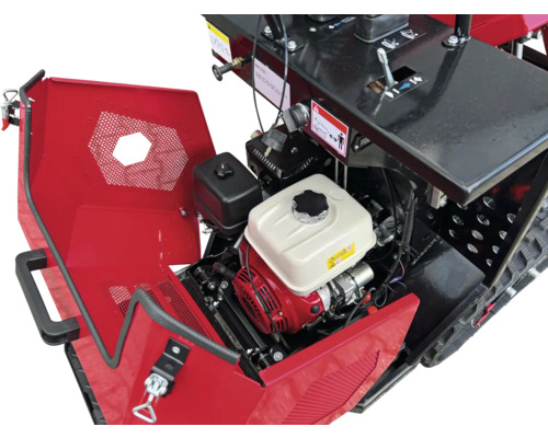 Detailansicht einer Motorfräse mit geöffneter Abdeckung und sichtbarem Motor