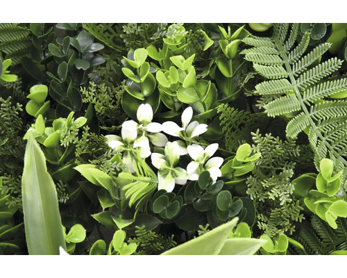 Künstliche Pflanzenwand mit verschiedenen grünen Blättern und weißen Blüten.