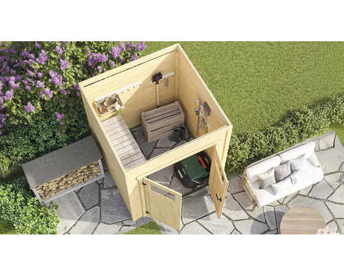 Gartenszene mit Gerätehaus, Holzregal, Rasenmäherroboter und Sitzgruppe auf einer gepflasterten Fläche