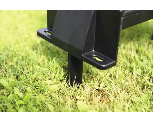 Detailansicht eines schwarzen Metallpfostens im Gras für die Gartenmontage