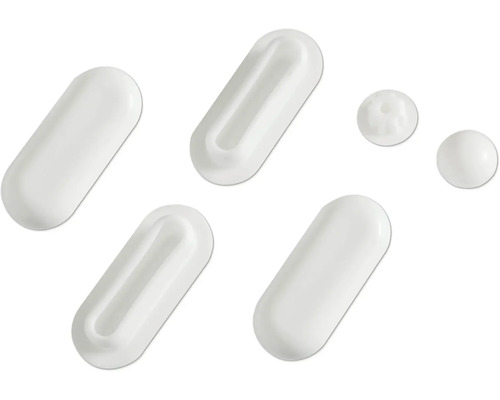 Mehrere weiße Kapseln und Tabletten