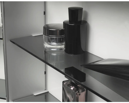 Regalboden aus Glas mit Kosmetikprodukten im Spiegelschrank