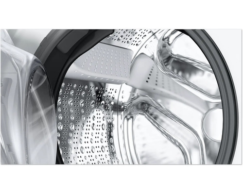 Innenansicht einer Waschmaschinentrommel aus Edelstahl mit Löchern