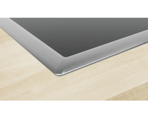 Detailansicht eines Kochfelds aus Glaskeramik mit Edelstahlrahmen