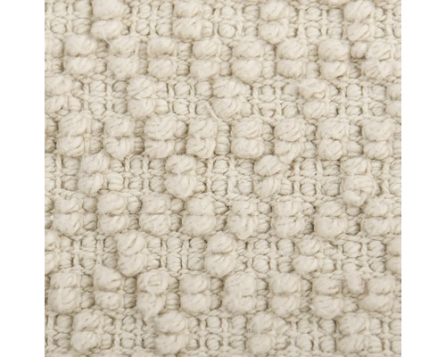 Nahaufnahme eines beigen Teppichs mit Noppenstruktur