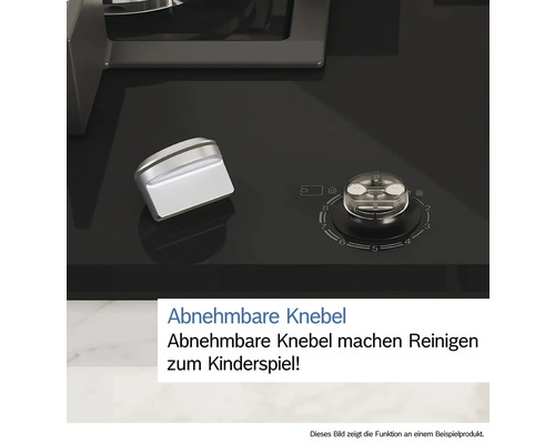 Detailansicht eines Kochfelds mit abnehmbaren Bedienknöpfen.