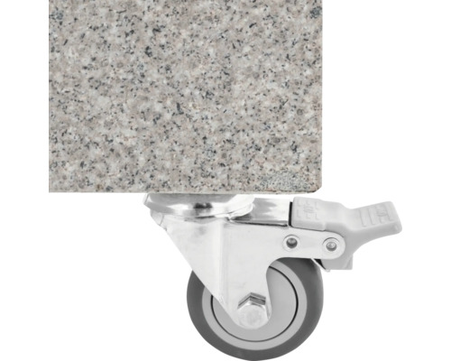 Detailaufnahme einer Lenkrolle mit Feststellbremse unter einer Platte