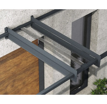 Detailansicht eines Vordachs mit anthrazitfarbenem Aluminiumrahmen und transparenter Glasabdeckung an einer Fassade.