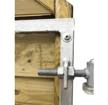 Detailansicht einer Torbefestigung mit Schrauben und Beschlägen an einer Holzwand.