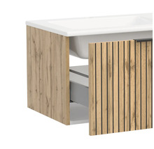 Badunterschrank mit Waschbecken in Holzoptik mit schwarzen Lamellen und einer geöffneten Schublade.